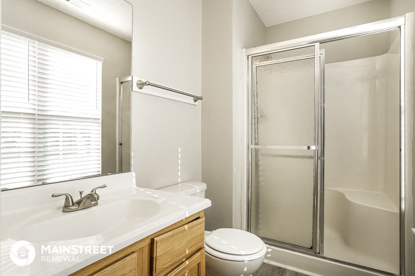 a bathroom with a sink and a shower and a toilet