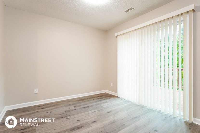 the living room of a new home with wood floors and white blinds