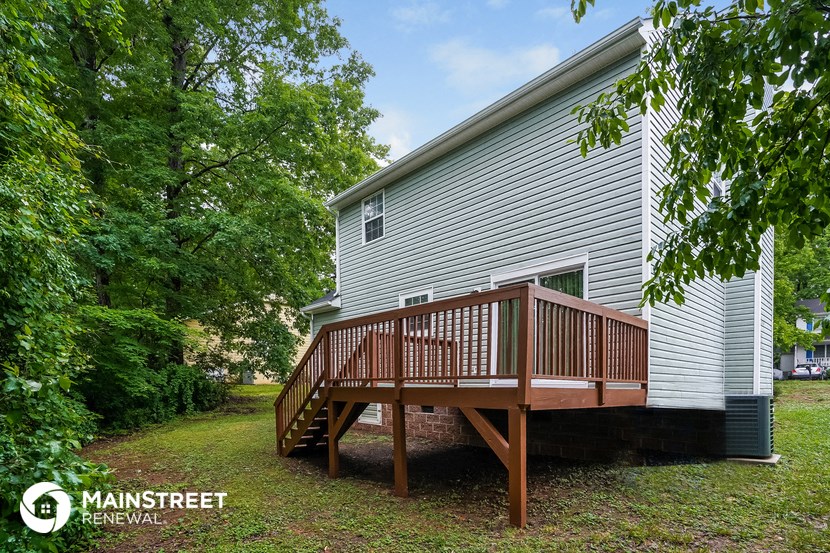 a house with a wooden deck on the side of it