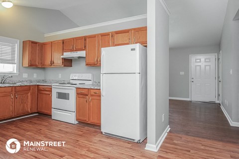 a kitchen with wooden cabinets and a white refrigerator