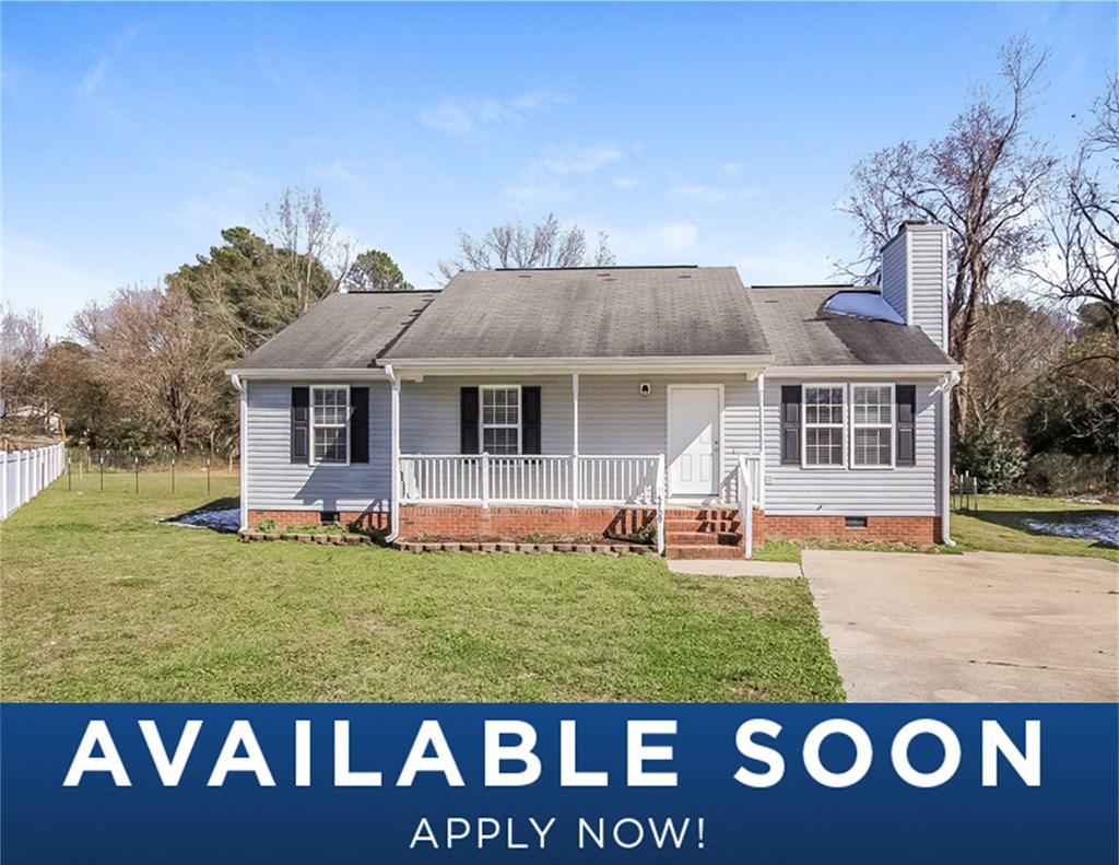 a small white house with a yard and a white fence