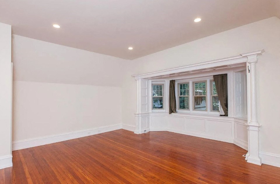 a living room with a hard wood floor and a window