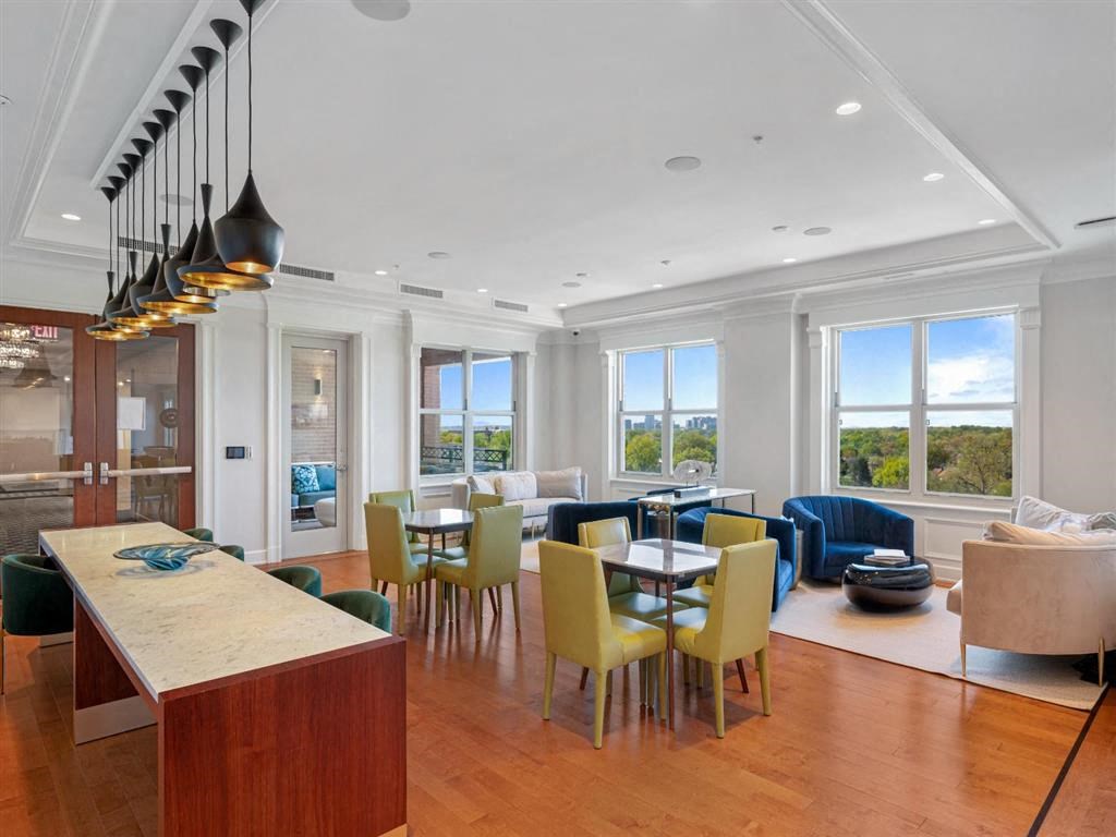 a living room and dining room with a table and chairs