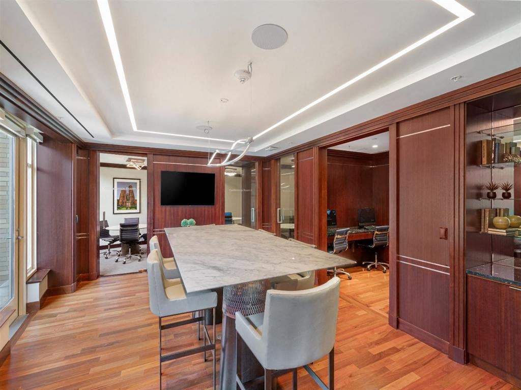 a dining room with a marble table and chairs