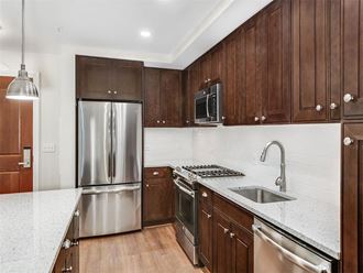 a kitchen with stainless steel appliances and wooden cabinets