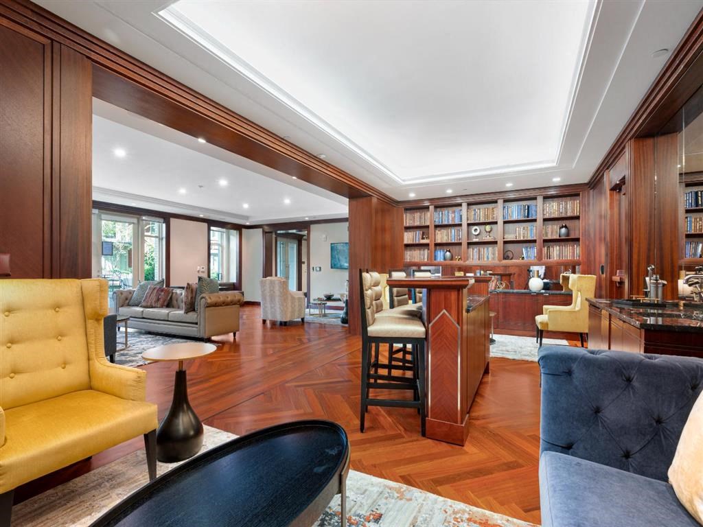 a living room with furniture and a bar and a library