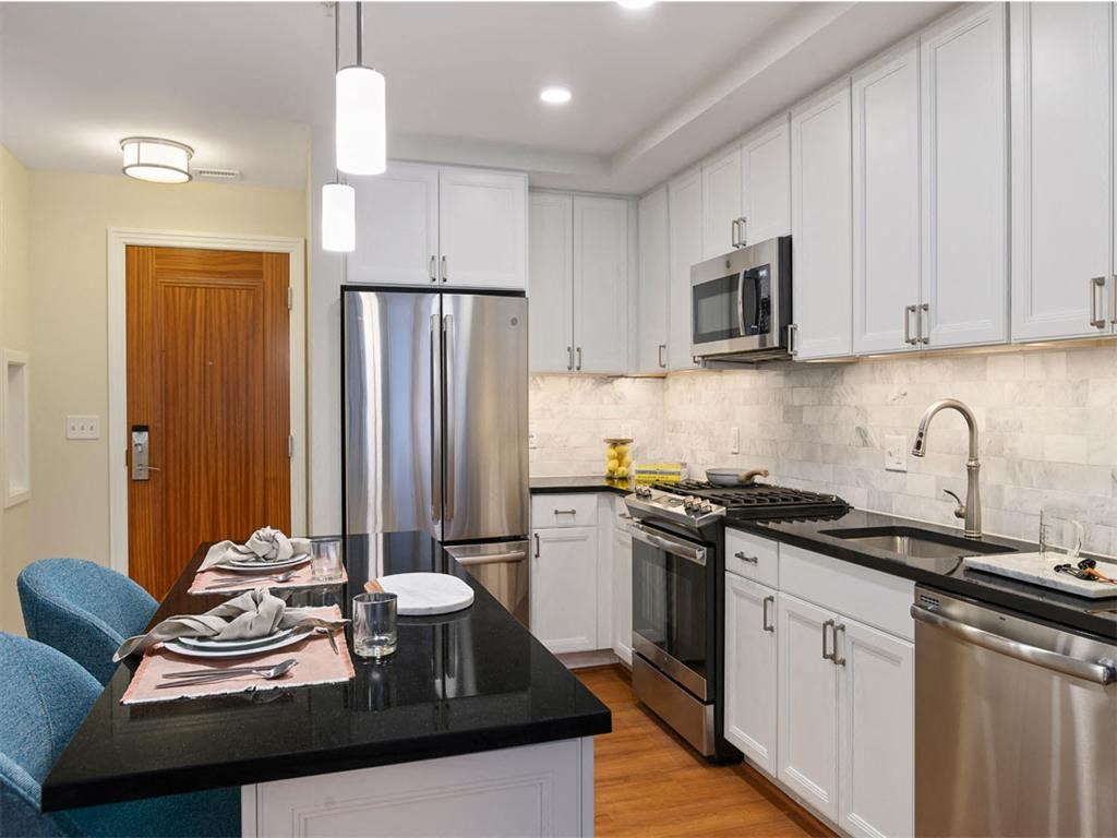a kitchen with a counter top and a refrigerator