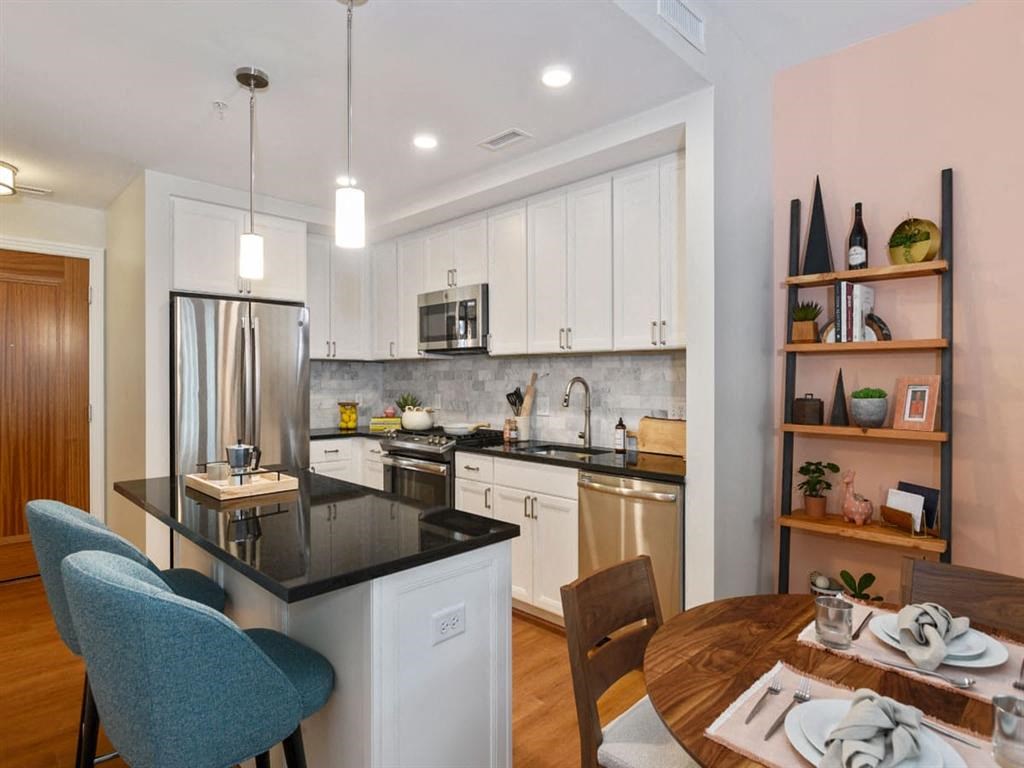 a kitchen and dining room with a table and chairs