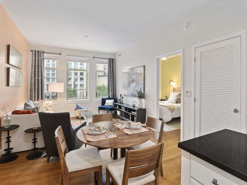 a living room and dining room with a table and chairs