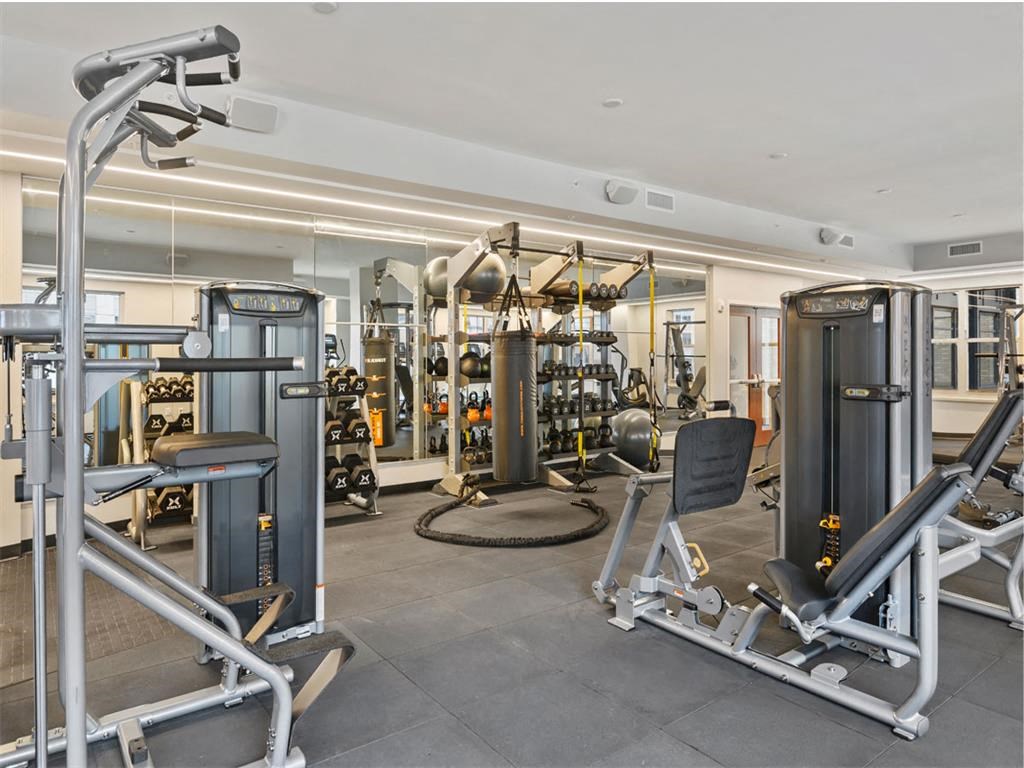 a gym with weights and cardio equipment in a home for sale