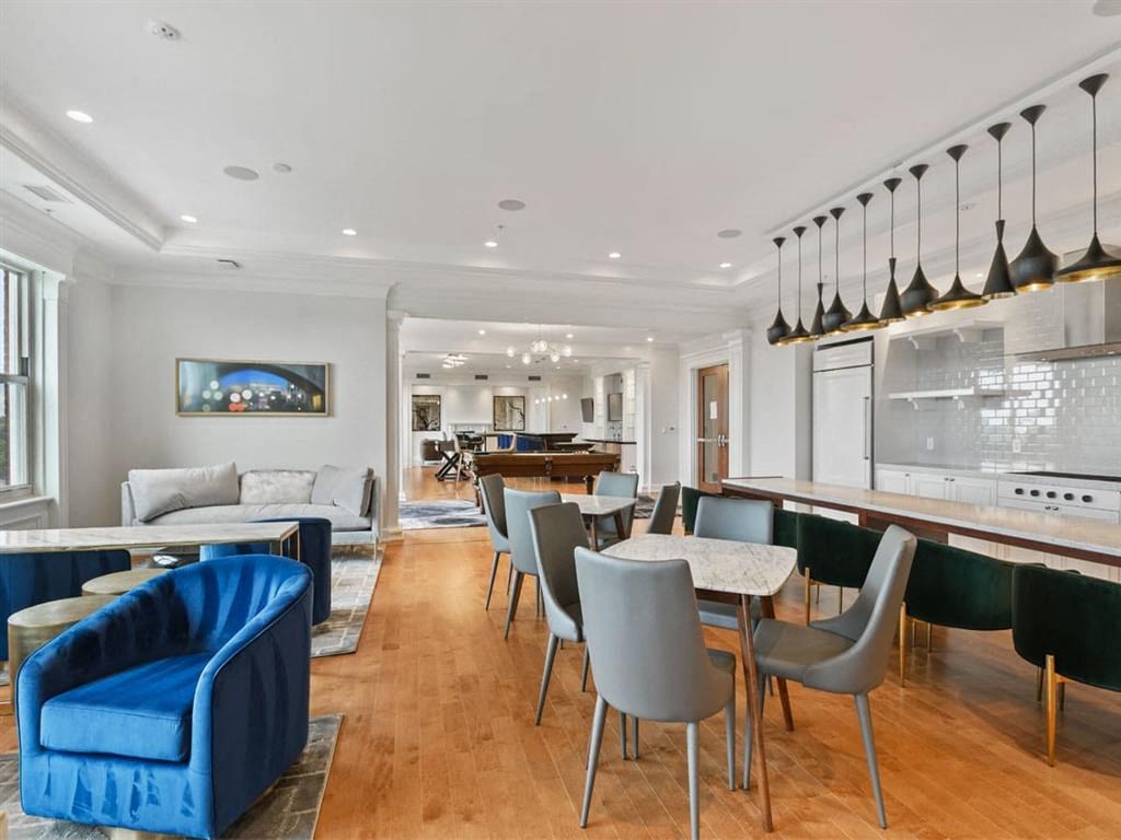 a living room and dining room with a table and chairs
