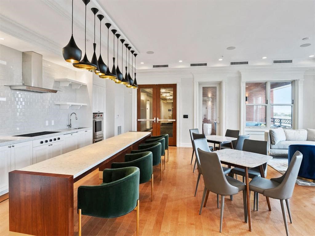 a kitchen and dining room with a long table and chairs