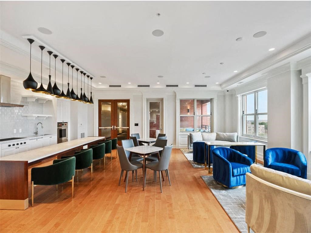 a large living room with a table and chairs and a kitchen