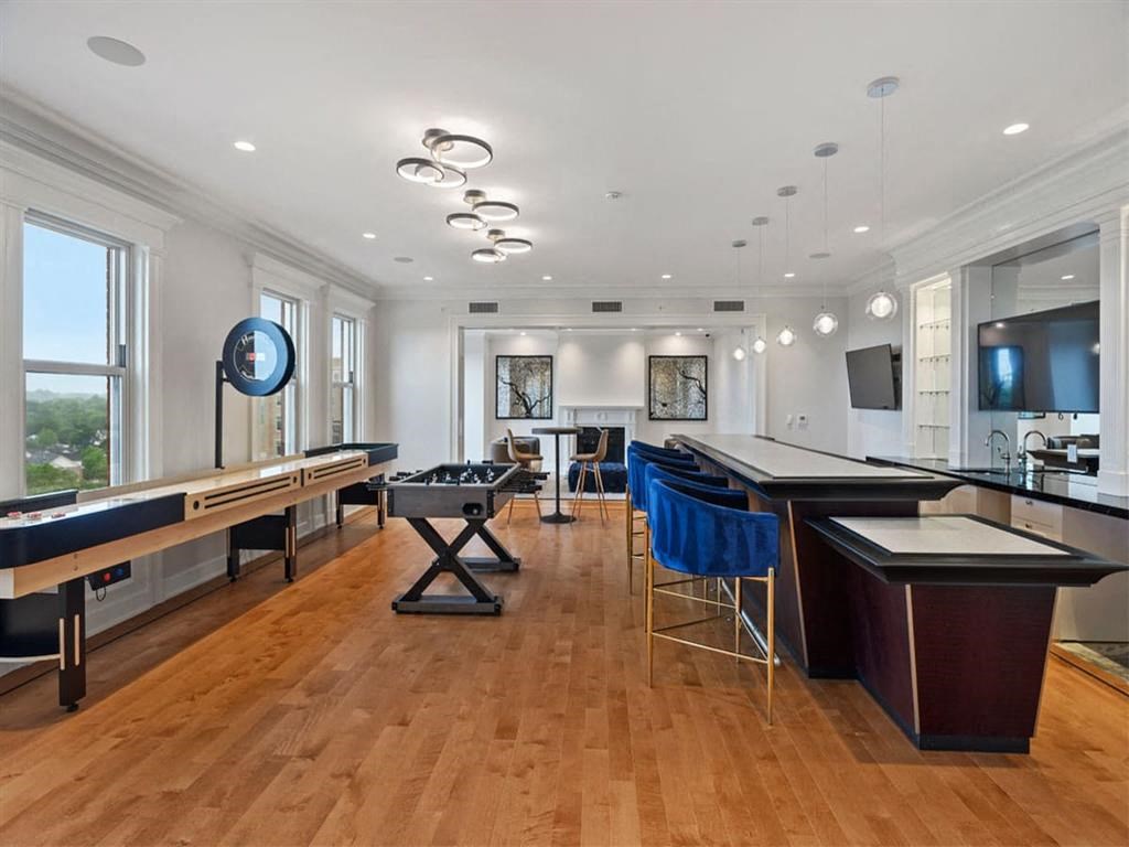 a large room with a bar and tables and a television