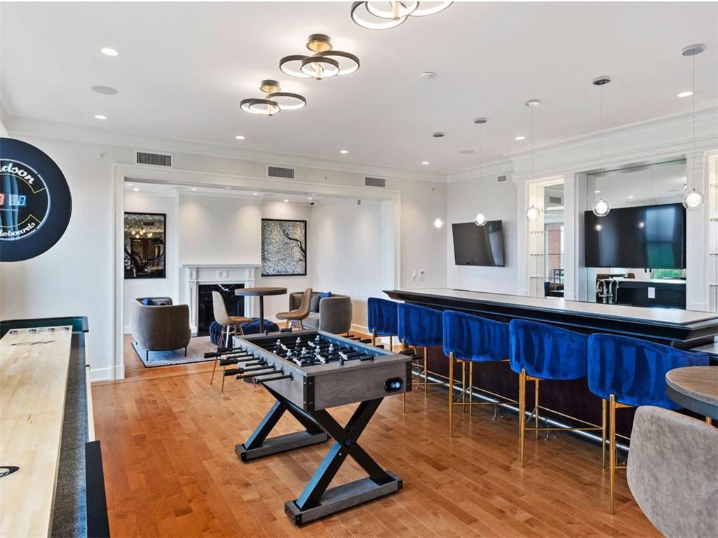 the game room has a bar and a foosball table