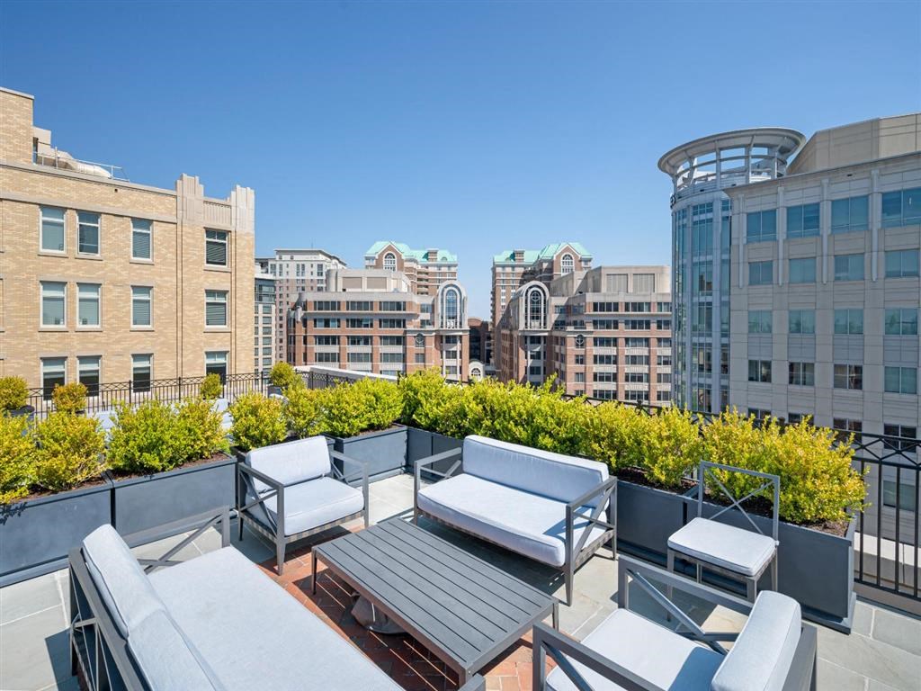 a rooftop patio with a view of the city