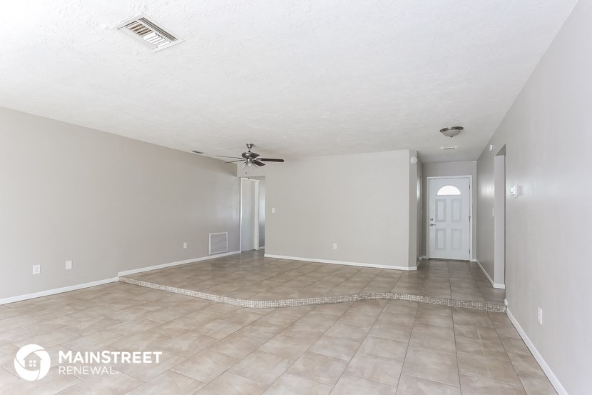 the living room and dining room are empty and ready to be remodeled