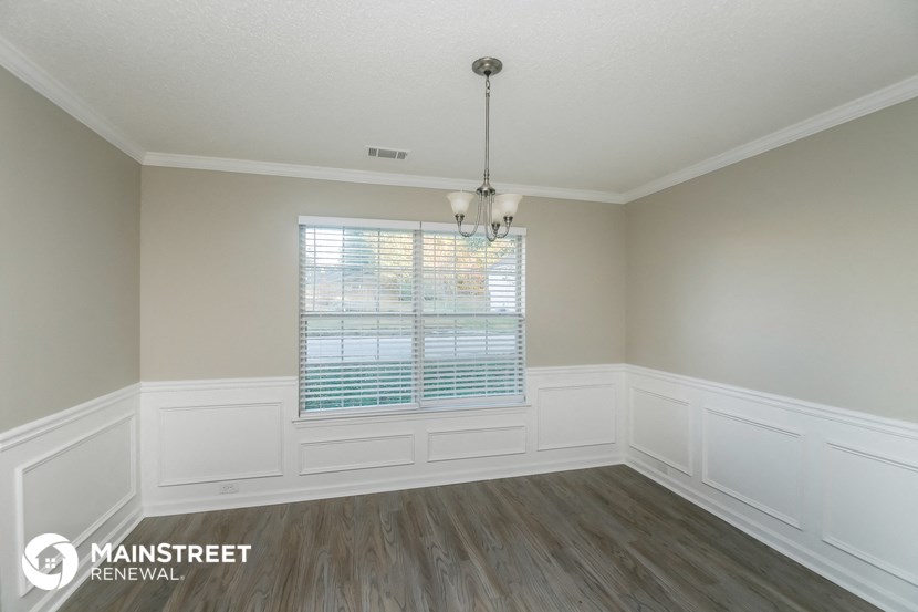 the living room after remodeling with wood flooring and white walls