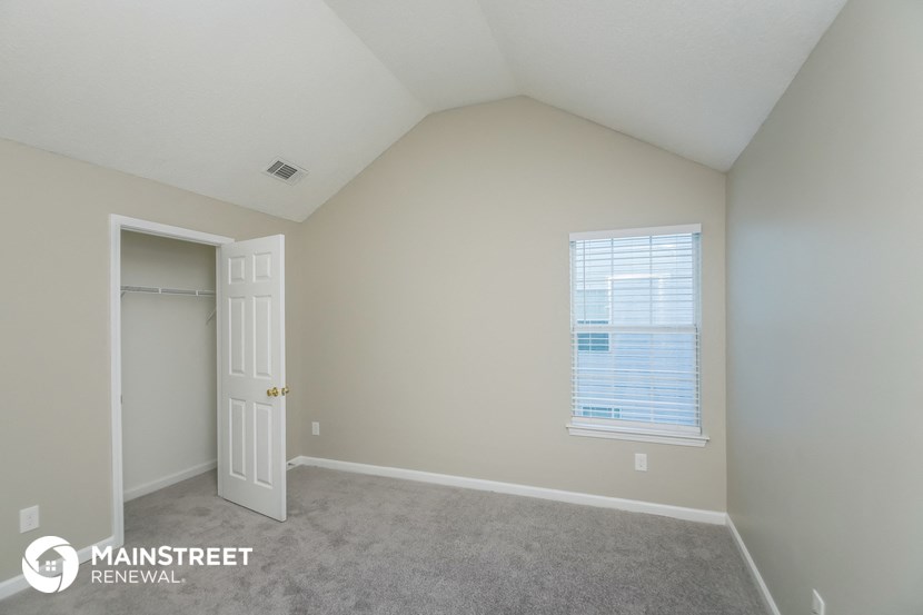 the upstairs bedroom has a closet and a door to the ensuite bathroom