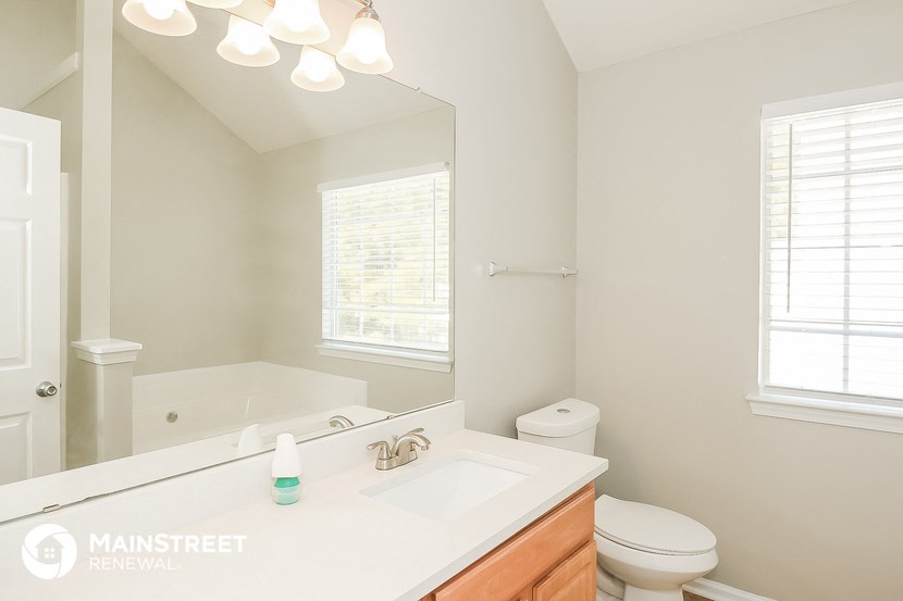 a bathroom with a sink and a toilet and a mirror