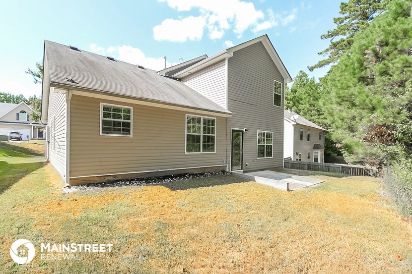 a backyard with a house and a patio
