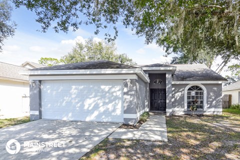 a white garage door in front of a house