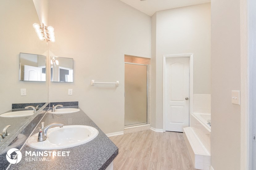 a bathroom with a sink and a mirror and a shower