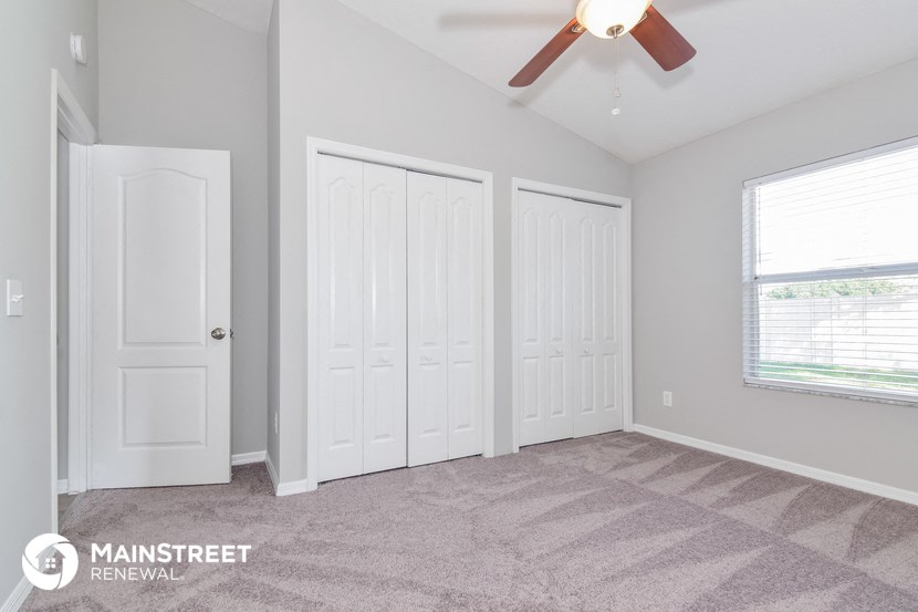 the master bedroom has 3 closets and a ceiling fan