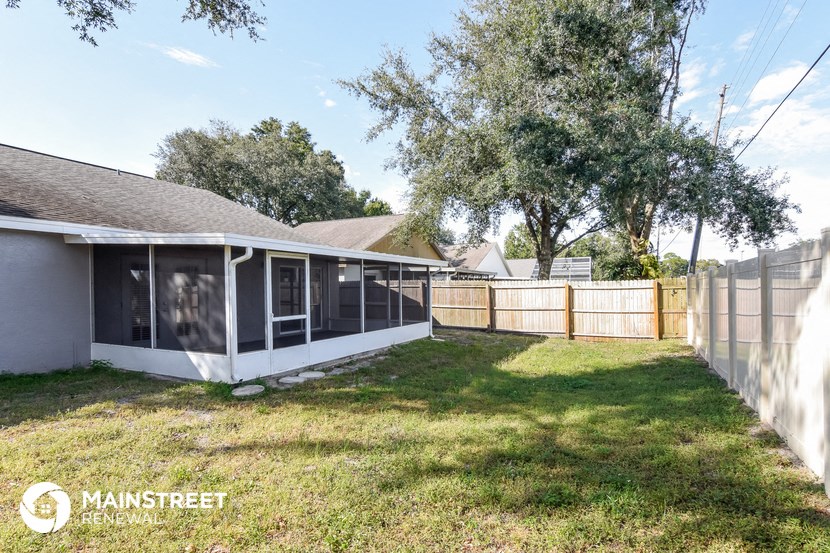 a backyard with a fence and a house