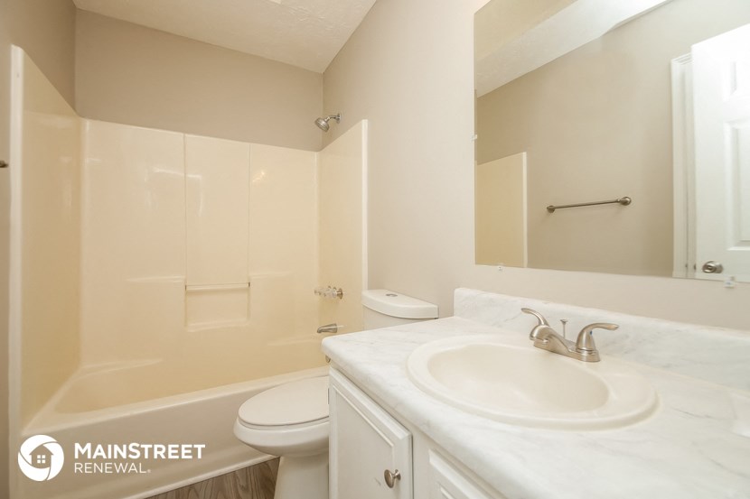 a bathroom with a sink and a toilet and a shower