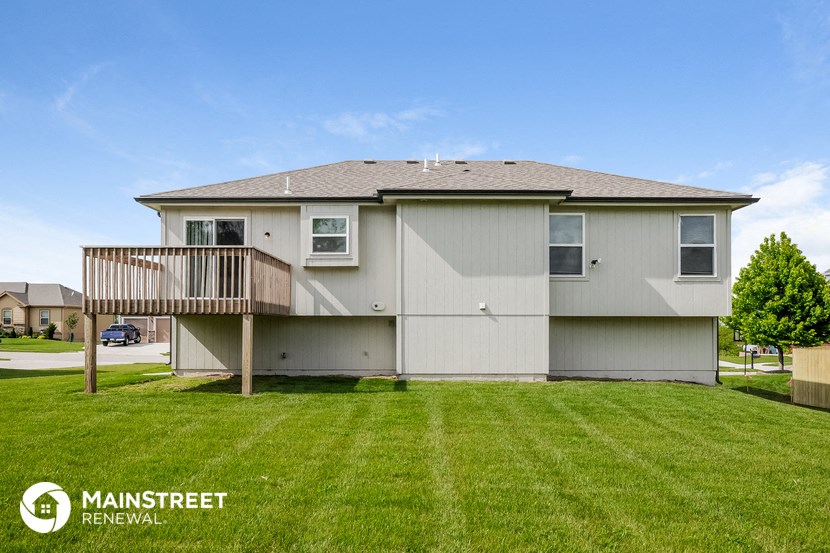 the exterior of a home with a yard and a deck