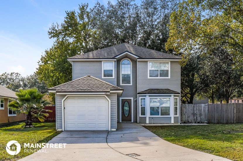 a with a driveway and a white garage door