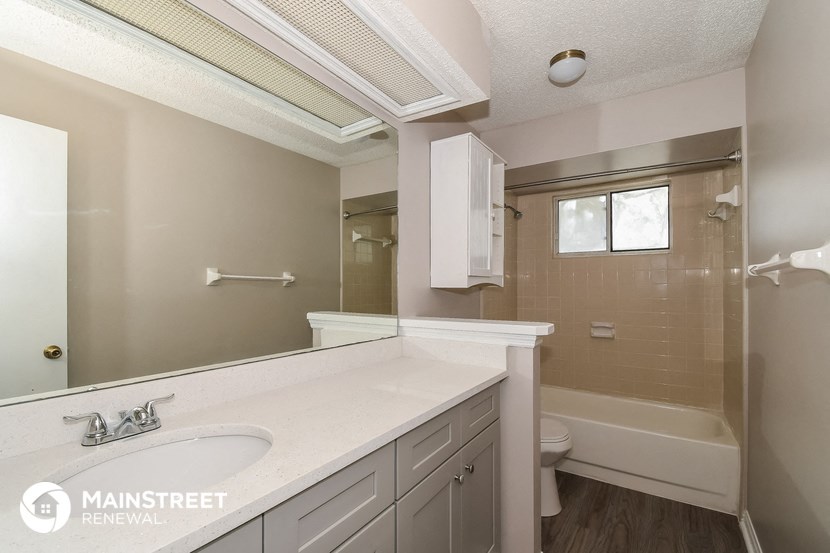a bathroom with a sink and a toilet and a shower