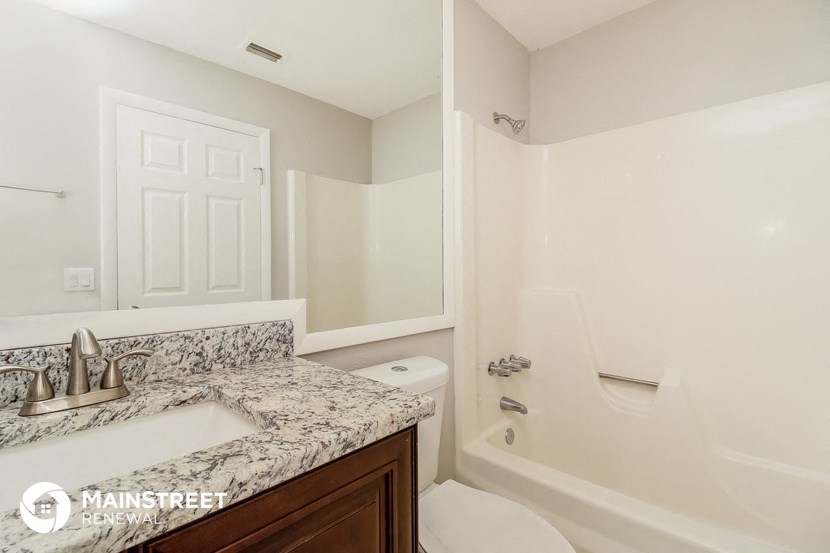 a bathroom with a sink and a toilet and a bath tub