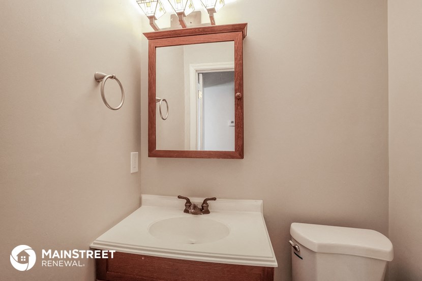 a bathroom with a sink and a mirror and a toilet