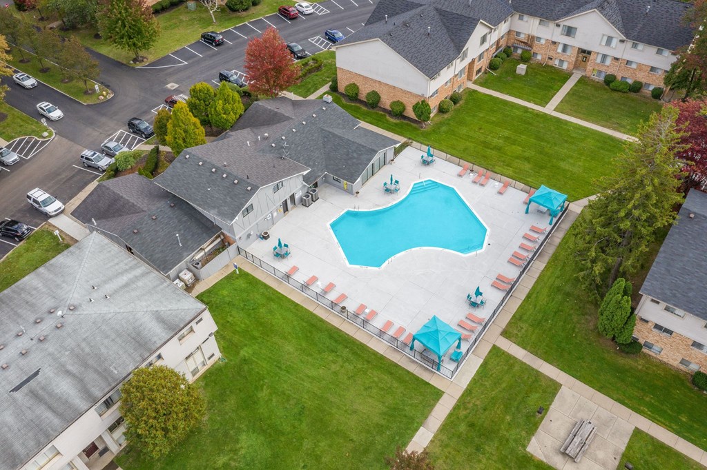 an aerial view of a swimming pool in the middle of a house