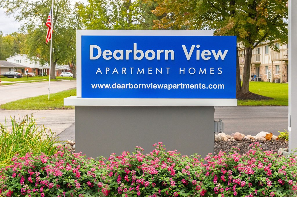 a sign view apartment homes in front of a street