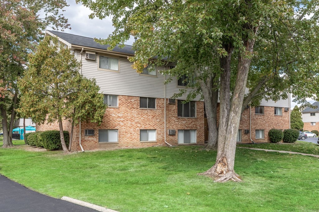 our apartments offer a green lawn and trees for residents to enjoy