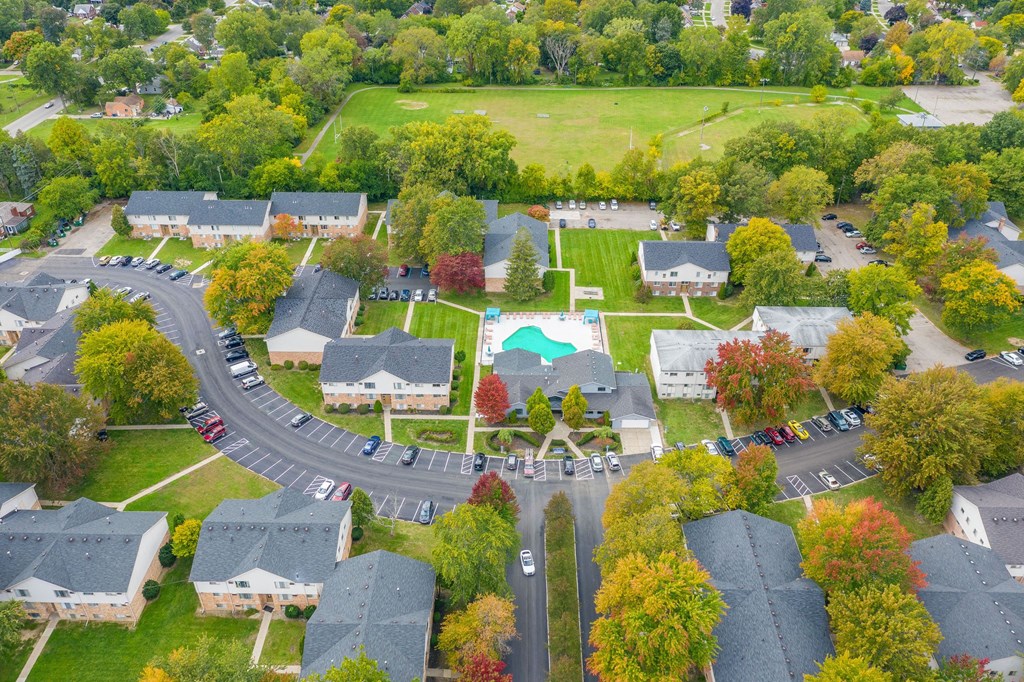 an aerial view of a neighborhood with houses and a swimming pool