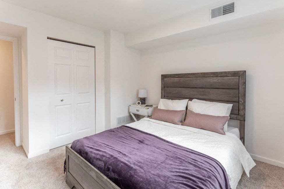 a bedroom with a bed and a closet