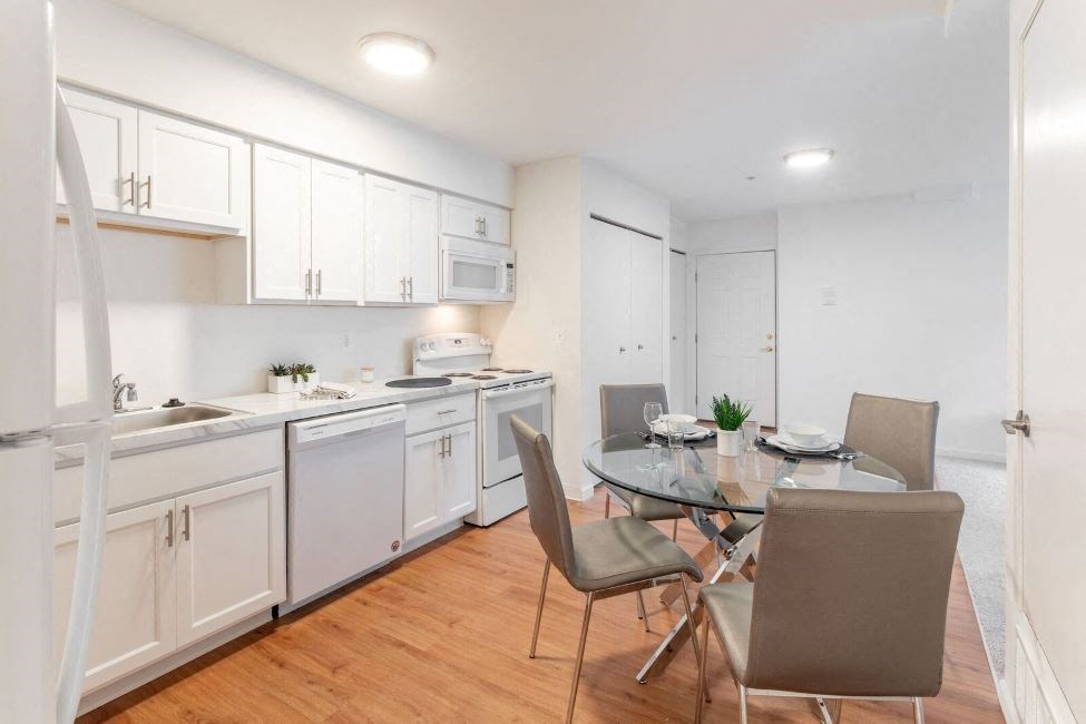 a kitchen and dining room with a table and chairs