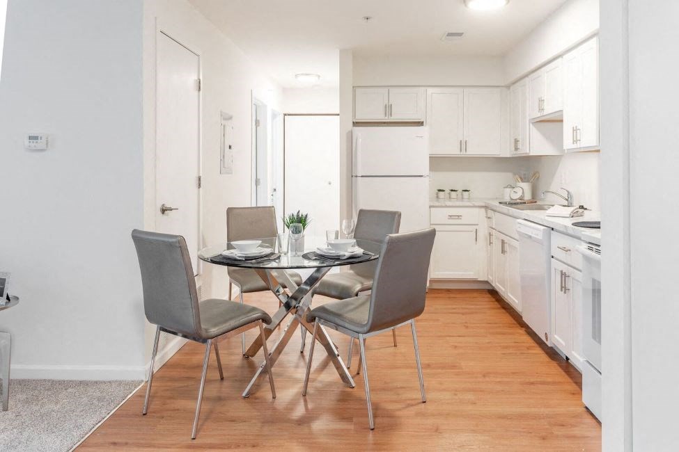 a kitchen and dining room with a table and chairs