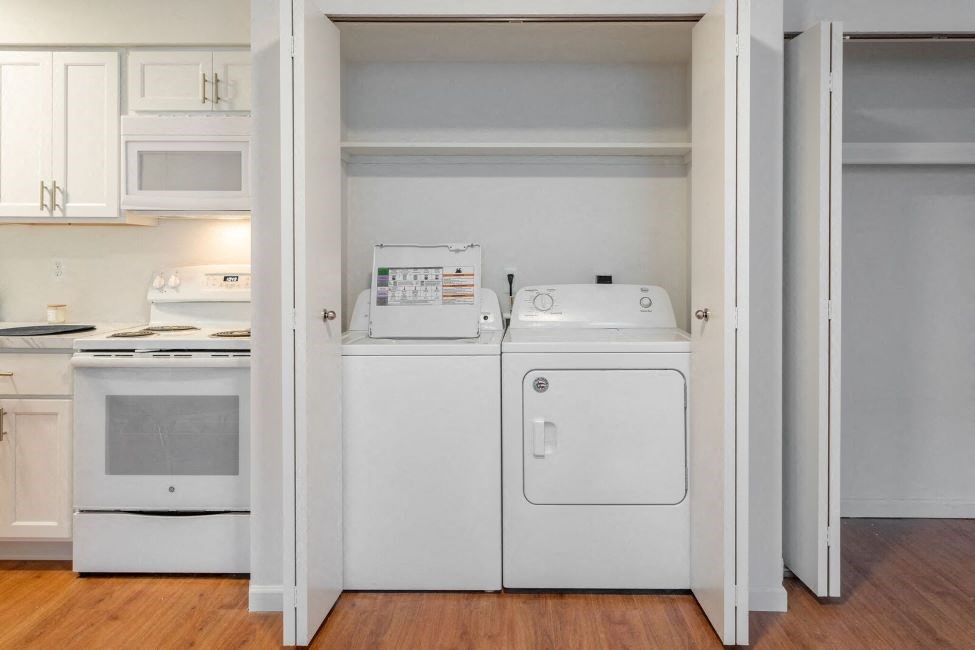 a white washer and dryer in a room with white appliances