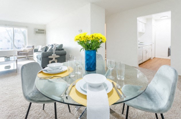 a dining room with a glass table and chairs