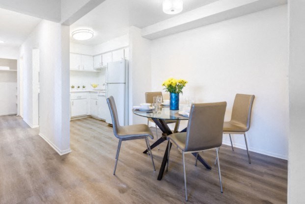 a dining room and kitchen with a table and chairs