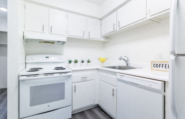 a white kitchen with white appliances and white cabinets
