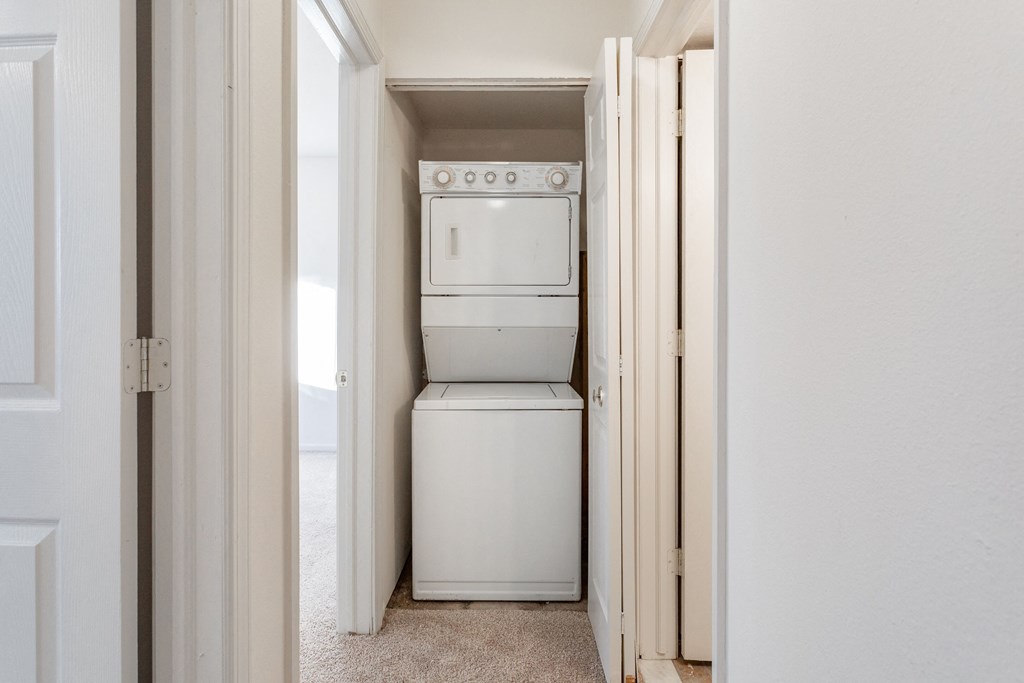 an empty laundry room with a washer and dryer