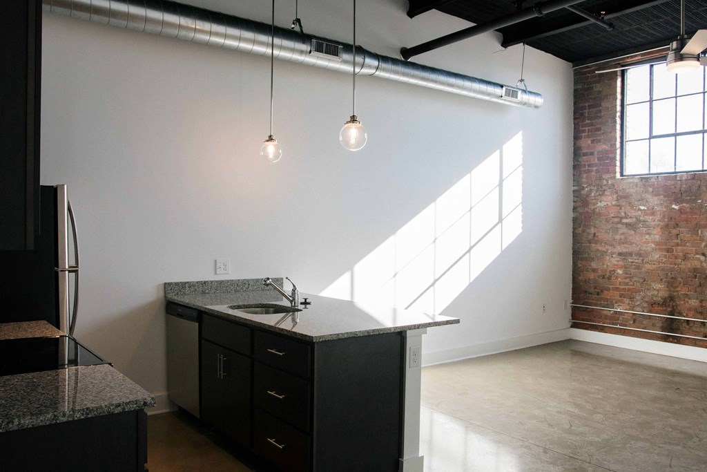 an empty room with a counter top in the middle