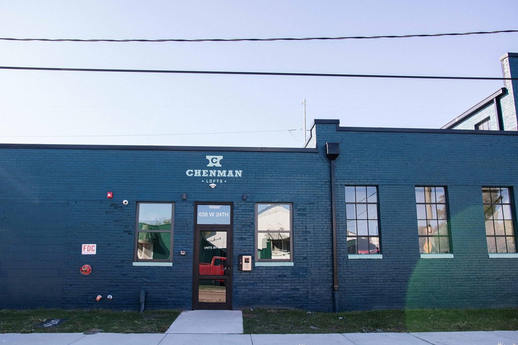 the side of a blue brick building with a sign that reads cincinnati city hall