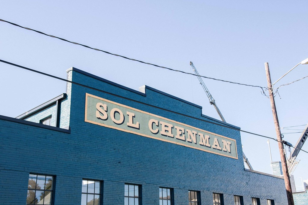 a sign on the side of a blue brick building